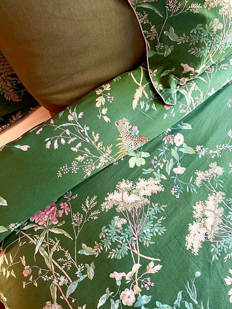 Les draps verts à motif de fleurs et d’oiseaux de la chambre botanique.